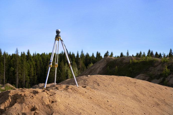 gray tripod on brown rock